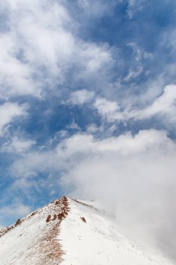 Winter mountain range with blue sky background with copy space.