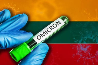 Litvanya 'daki Omikron salgını. Mavi lastik eldivenli bir el Litvanya bayrağının önünde üzerinde covid-19 virüsü olan bir tüp tutuyor. Omicron varyant salgını kavramı