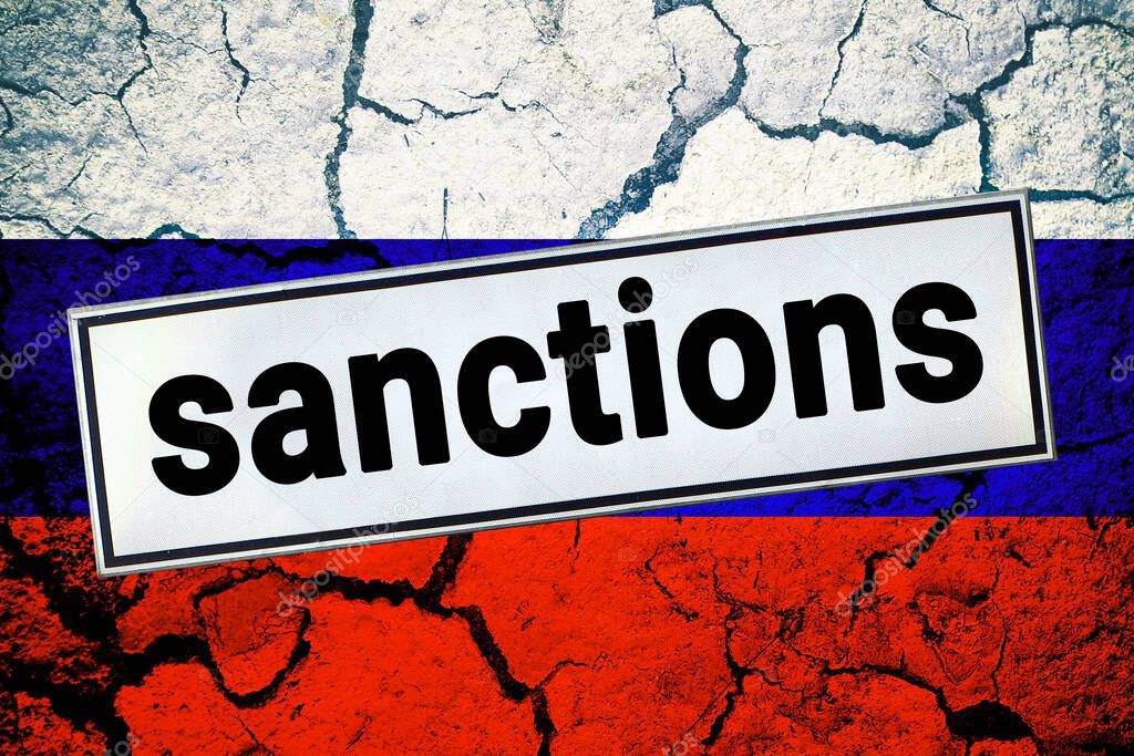 Sanction sign on a cracked Russian flag. Sanctions economic and geopolitical restrictions on Russia due to the military conflict concept.