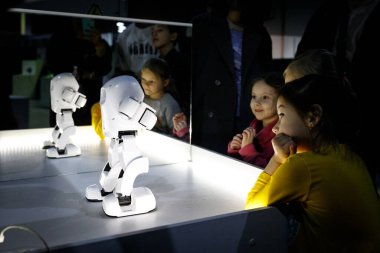Robot festivalindeki beyaz robotun etrafındaki çocuklar. Almaty, Kazakistan - 19 Şubat 2022