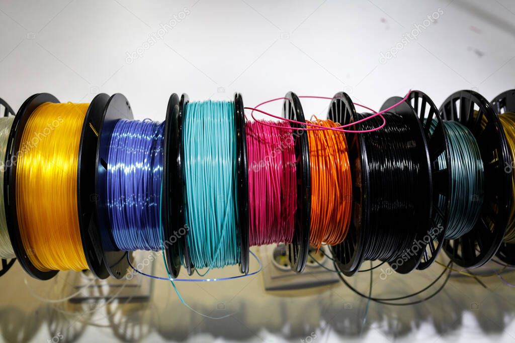 Top view of Colorful plastic PLA and ABS spools with thread for printing on a 3D pen
