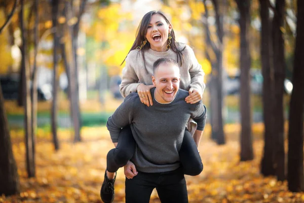 Happy Man Carries Laughing Woman His Back Enjoy Last Warm — Fotografia de Stock
