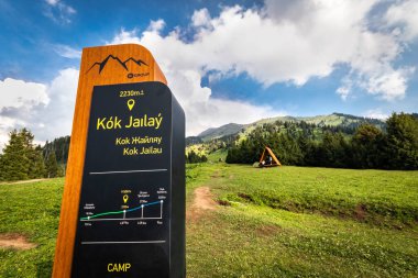Tourist information stand in the picturesque Almaty tourist mountain tract Kok Zhailau. Almaty, Kazakhstan - June 06, 2022