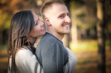 Man and woman hugging smiling and having fun together in outdoor leisure activity.