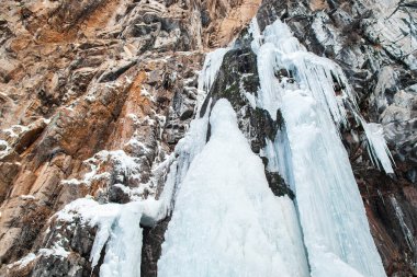 Frozen Butakov Waterfall in the Butakovsky gorge in the vicinity of the city of Almaty in winter day.