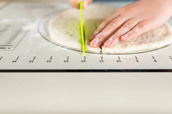 The process of cooking from dough on a baking mat with markings, copy space.