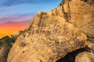 Almaty bölgesindeki Ili Nehri 'ndeki Tamgaly tas arazisindeki bir kaya taşında antik yazılar..