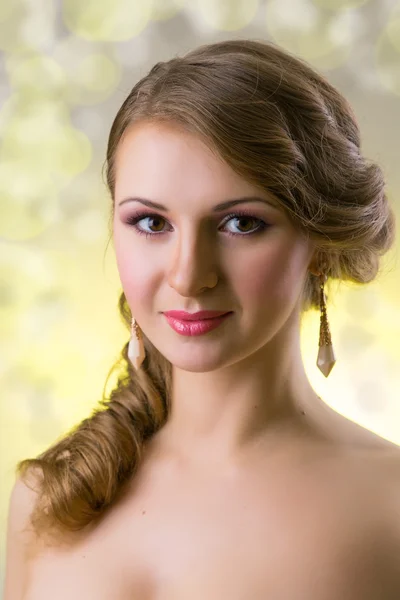 Young girl with makeup and beautiful big earrings — Stock Photo, Image