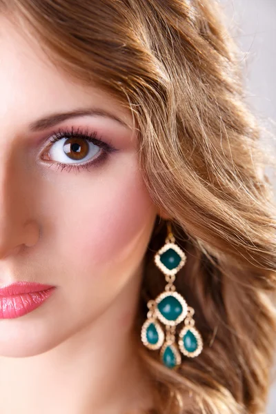 Young girl with makeup and beautiful big earrings — Stock Photo, Image