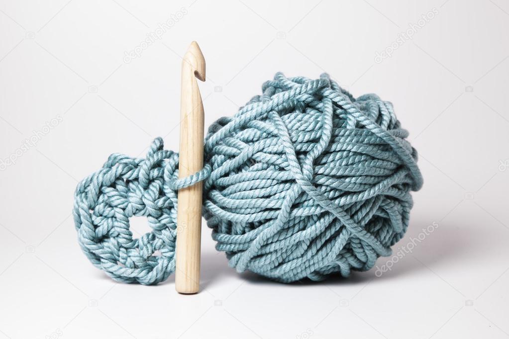 A ball of thick wool with and special wood needle.