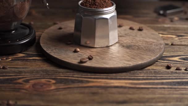 Zubereitung von köstlichem schwarzen Kaffee italienischen Mokka. Geysir-Kaffeemaschine auf einem Holztisch vor dunklem Hintergrund — Stockvideo