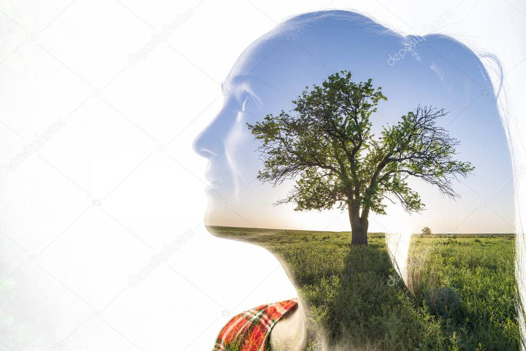 A combination of a silhouette of a woman face and a landscape with tree on a white background. Concept of the unity of nature and people, inner peace, growth, cleanliness and positive thinking