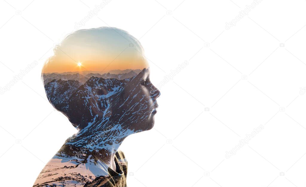 Isolated combination of the silhouette of a child face and a landscape with mountains. Concept of the connection between man and nature