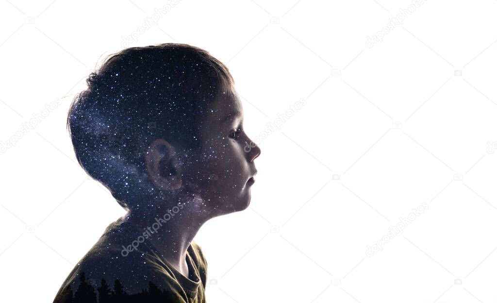 Isolated combination of the silhouette of a child face and the stars of the Milky Way. Concept of the connection between man and the universe, new discoveries and space exploration