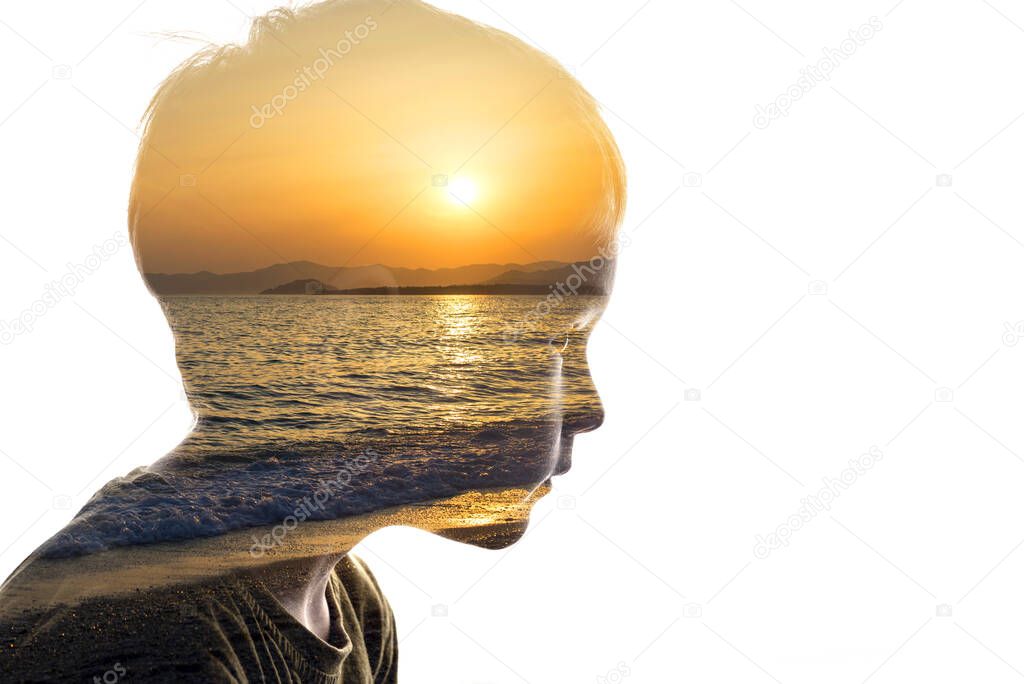 Isolated combination of the silhouette of a child face and a seascape with a sunset. Concept of unity of nature and people, inner peace, caring for the ecology