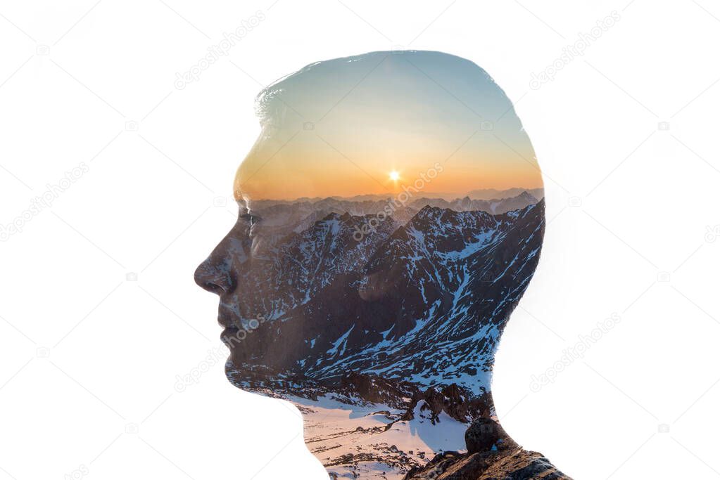 Isolated combination of the silhouette of a man face and a landscape with mountains and the setting sun. Concept of the connection between man and nature