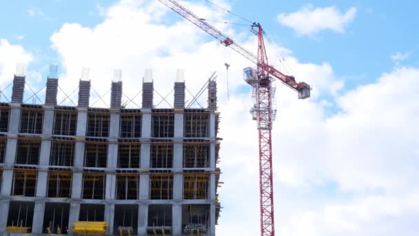Residential building construction industry. Equity participation in the construction of a residential apartment building. Mortgage. Building under construction and a crane on the background of the sky — Stock Video