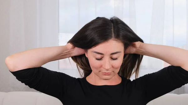 Caucasian woman doing head massage and treating herself. Caring for the soul and body. Manage the stress that comes with the end of the year, give yourself time to restore.