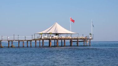 Türkiye 'de Akdeniz kıyısındaki popüler turistik tatil beldesinde küçük ahşap iskele ve deniz suyu