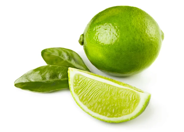 Whole and sliced limes — Stock Photo, Image