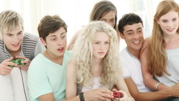 Панорама подростков, играющих в видеоигры в гостиной — стоковое видео