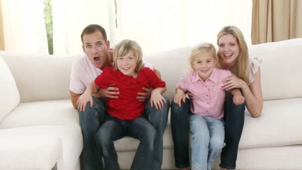 Family celebrating a success in a football match at home — Stock Video