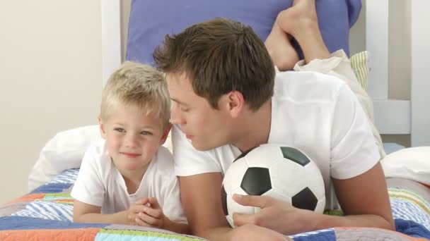 Otec a syn hraje s míčem v ložnici — Stock video
