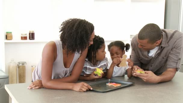 Afro-American family eating confectionery in the kitchen — Stock Video