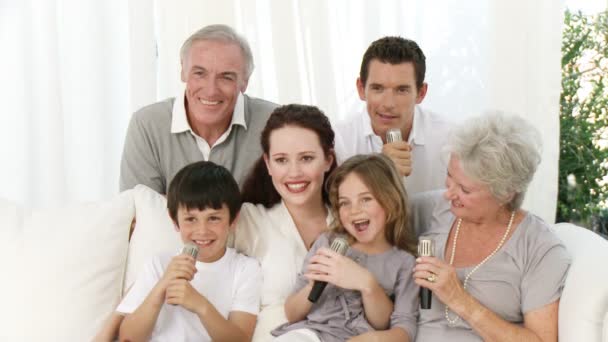 Family singing karaoke at home — Stock Video