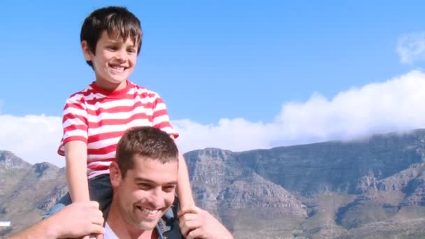 Отец с сыном на плечах — стоковое видео