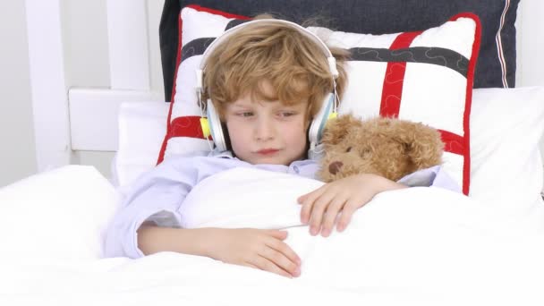 Young Boy on bed listening to Music — Stock Video