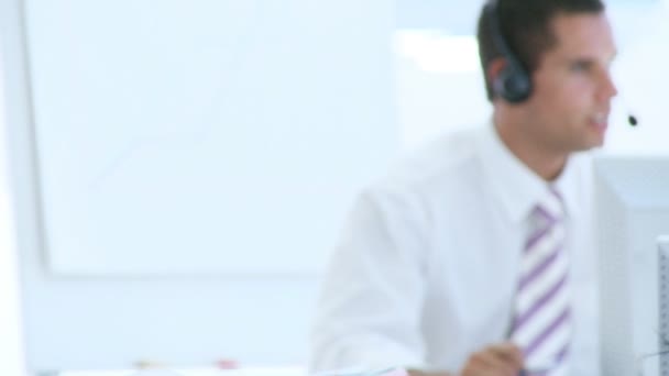 Smiling businesswoman in a call center with her team — Stock Video