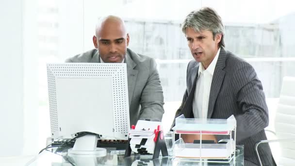 Two disappointed businessmen working at a computer — Stock Video