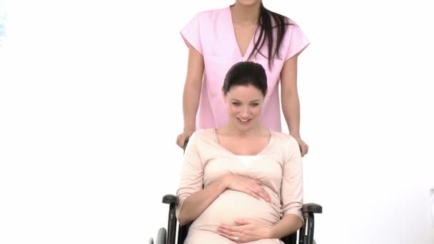 Enthusiastic pregnant woman sitting on wheelchair in the hospital — Stock Video