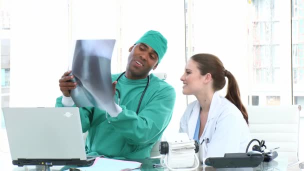 Concentrated doctors examining an x-ray — Stock Video