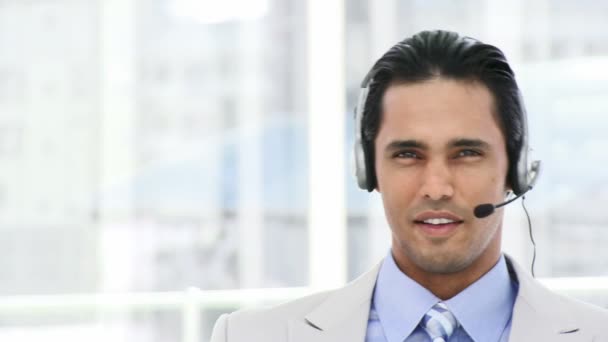 Self-assured businessman using a headset — Stock Video