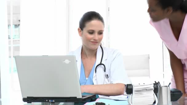 Young female doctors talking in the office — Stock Video