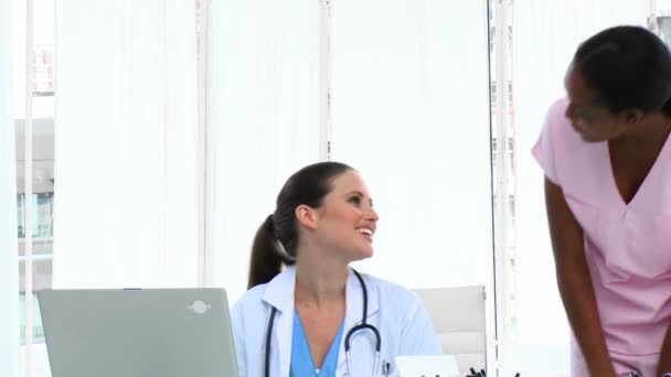 Pretty female doctors talking in the office — Stock Video