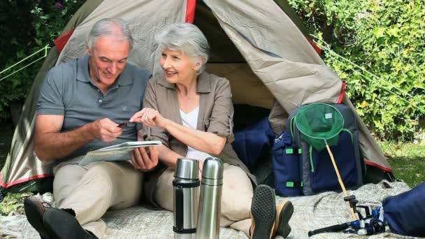 Seniors sitting near a tent — Stock Video