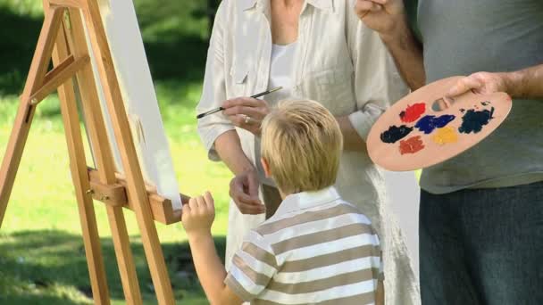 Niño y abuelos pintando un lienzo — Vídeos de Stock