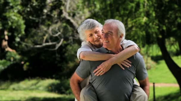 Old man carrying his wife — Stock Video