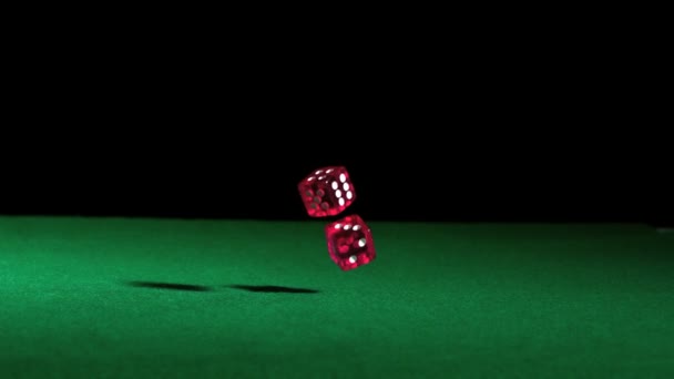 Pink dice falling on green table — Stock Video