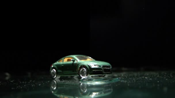 Toy car rolling over water — Stock Video