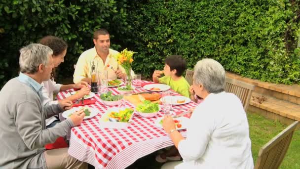 Family lunch with grandparents in the garden — Stock Video
