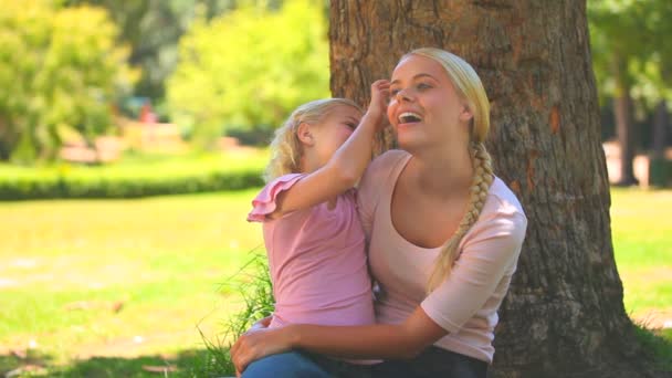 Young girl giving a flower to her mother — Stock Video