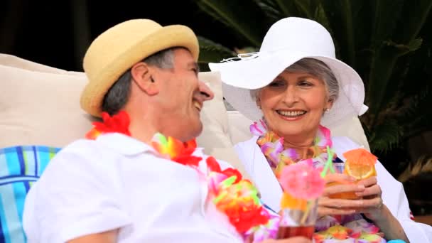 Senior couple laughing and sharing cocktails — Stock Video