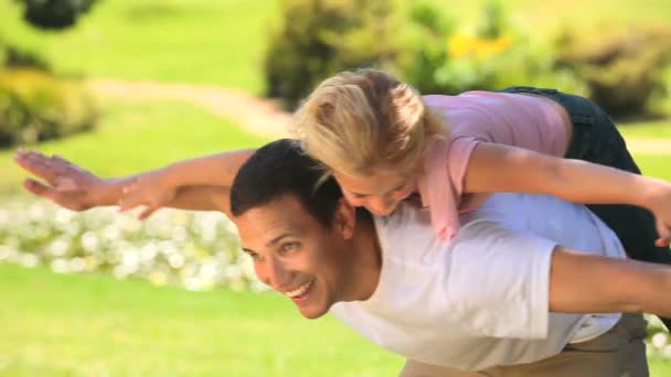 Young man playing with his daughter — Stock Video