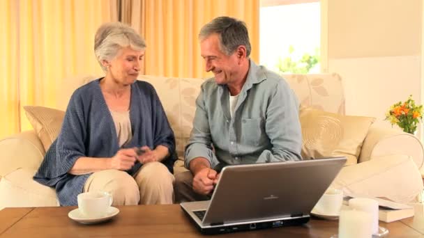 Mature couple using a credit card — Stock Video