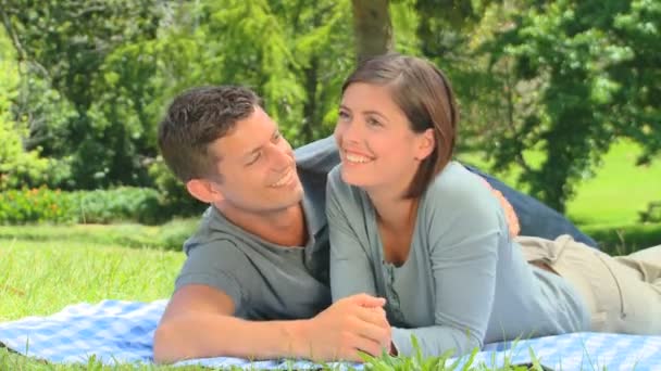 Young couple lying on the grass — Stock Video