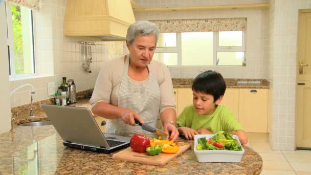 Frau zeigt ihrem Enkel, wie man kocht — Stockvideo